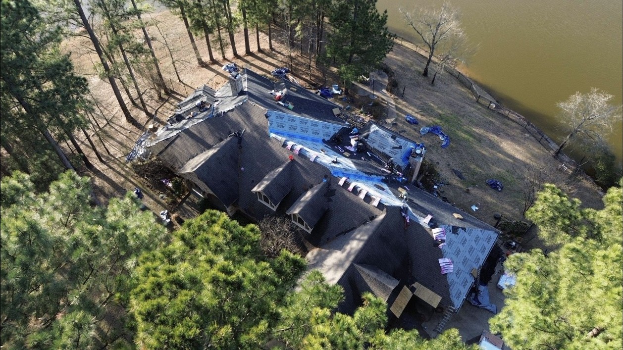 Roofing installation in progress on a large residential project