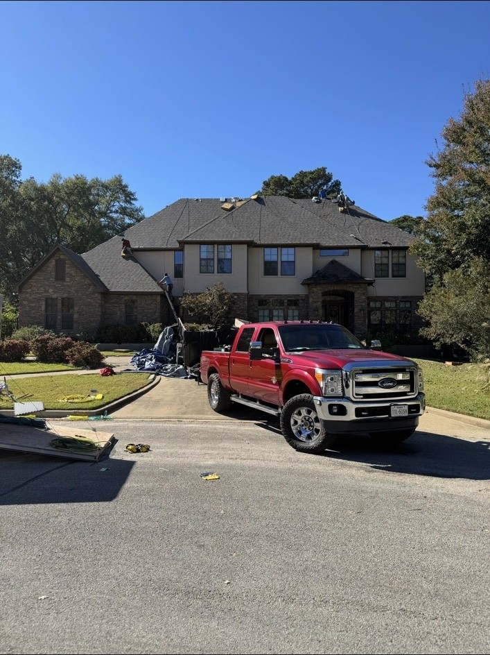 JR Roofing equipment and vehicles at a residential project